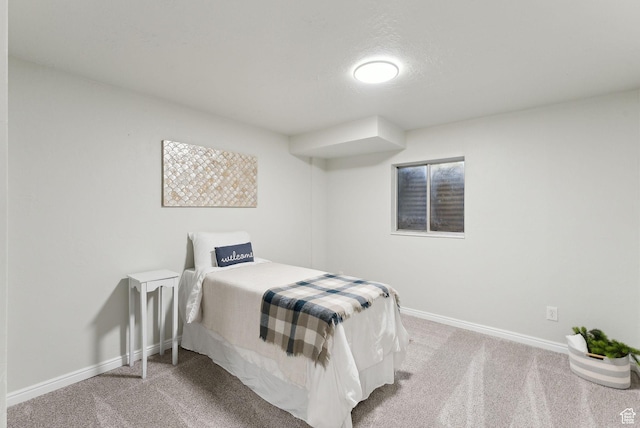 bedroom featuring carpet and baseboards