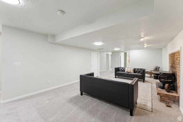 carpeted living area with a textured ceiling and baseboards