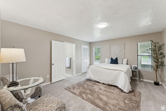 carpeted bedroom with multiple windows, baseboards, and a textured ceiling