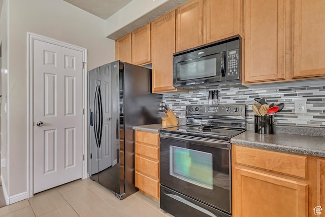 6297 W Traveler Ln, West Jordan, UT 84081 - kitchen with black appliances, backsplash, light tile patterned flooring, and dark countertops
