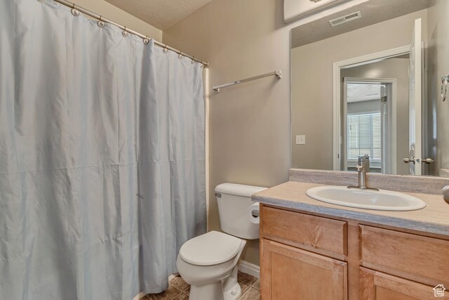 6297 W Traveler Ln, West Jordan, UT 84081 - bathroom with tile patterned flooring, toilet, vanity, a shower with shower curtain, and baseboards