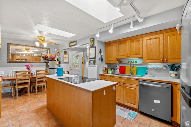 7472 S Silver Cir, West Jordan, UT 84084 - kitchen with appliances with stainless steel finishes, a sink, a skylight, track lighting, and a center island