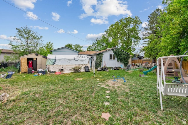 7472 S Silver Cir, West Jordan, UT 84084 - view of yard featuring a playground, a shed, and an outbuilding