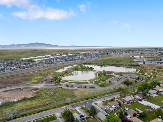 aerial overview of property's location featuring a water and mountain view and nearby suburban area