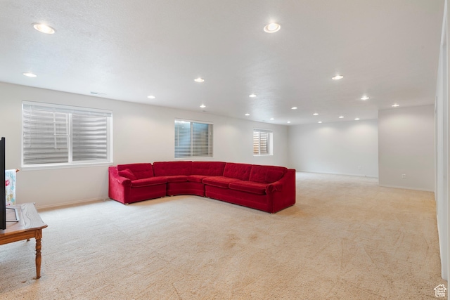 carpeted living room featuring recessed lighting and baseboards