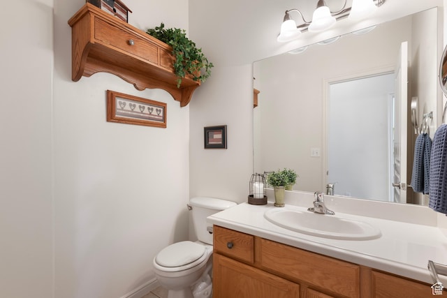 bathroom featuring toilet and vanity
