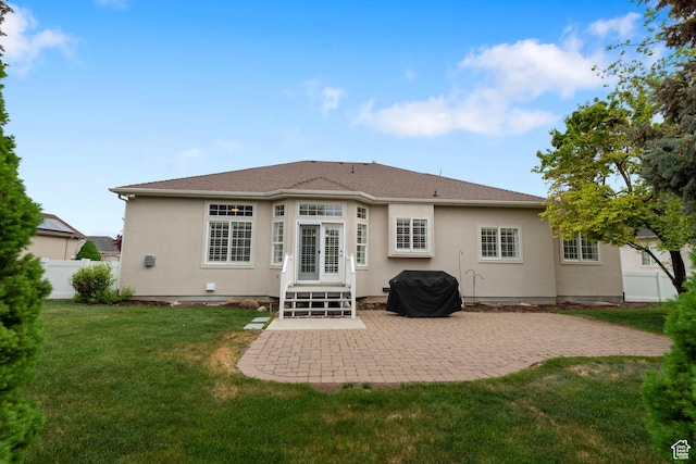 rear view of house featuring a patio and stucco siding