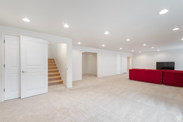 finished basement featuring carpet, recessed lighting, and stairs