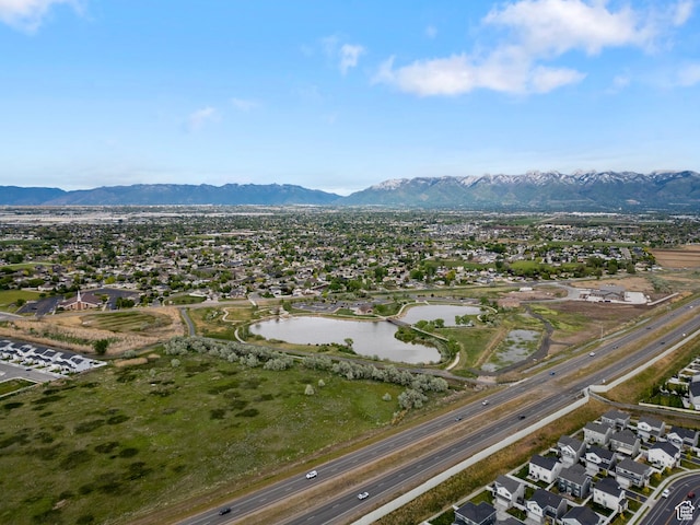 aerial view of residential area featuring a water and mountain view
