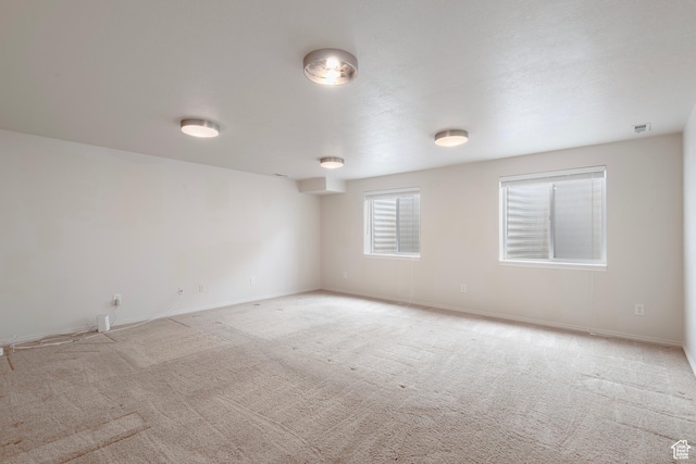 empty room with carpet floors and baseboards