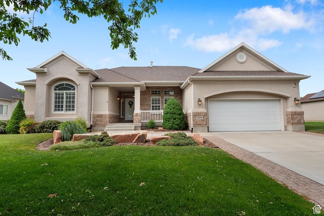 view of front of house with brick siding, a front lawn, concrete driveway, stucco siding, and a garage