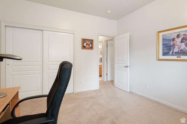office area featuring light colored carpet and baseboards
