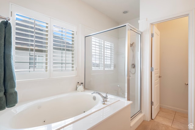 full bathroom featuring a shower stall, a tub with jets, and tile patterned flooring