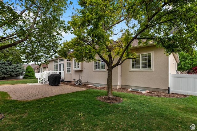 rear view of property featuring a patio area and stucco siding