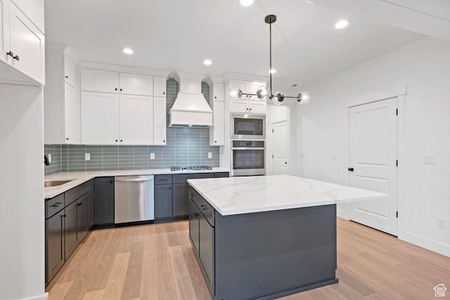 kitchen featuring stainless steel appliances, custom exhaust hood, light wood-type flooring, tasteful backsplash, and recessed lighting