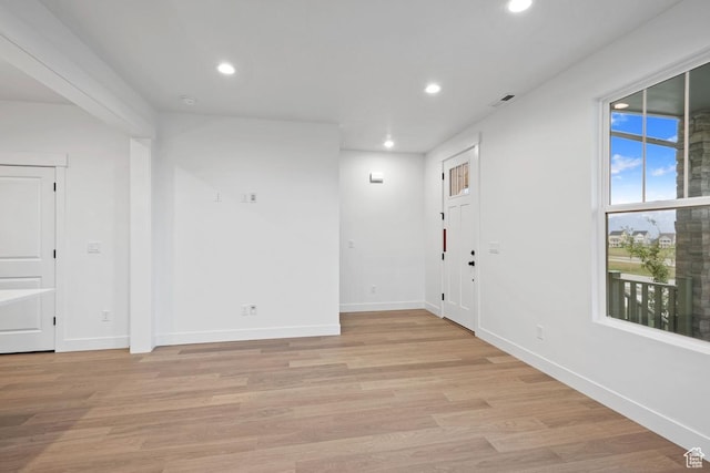 unfurnished room featuring recessed lighting, baseboards, and light wood-type flooring
