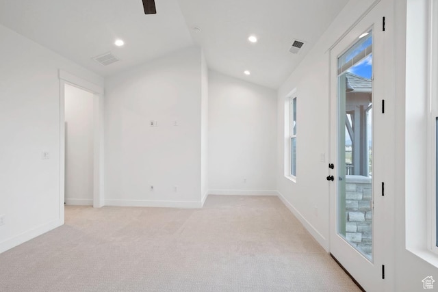 empty room featuring light colored carpet, vaulted ceiling, recessed lighting, and baseboards