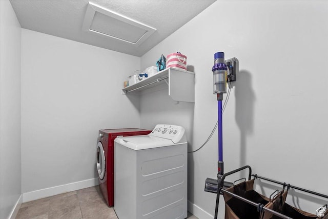 laundry area featuring attic access, washing machine and dryer, and baseboards
