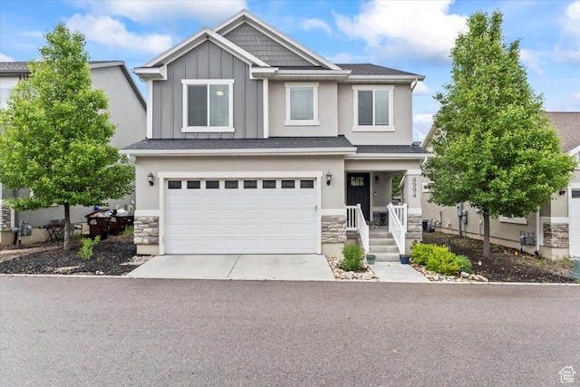 view of front of home with stone siding, board and batten siding, a garage, and driveway