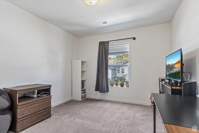 carpeted office space featuring baseboards