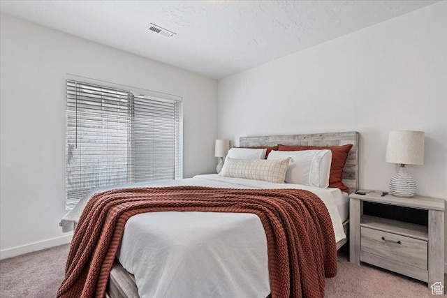 carpeted bedroom featuring baseboards