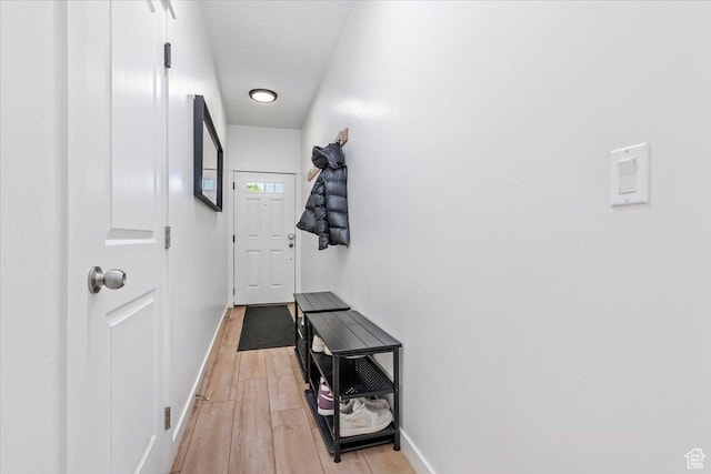 entryway with baseboards and light wood-type flooring