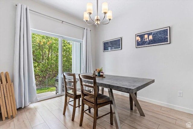 dining space with a chandelier, light wood finished floors, and radiator