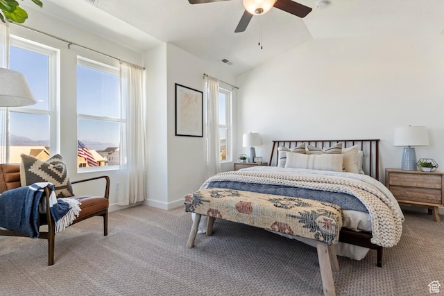 bedroom featuring light carpet, multiple windows, ceiling fan, and lofted ceiling