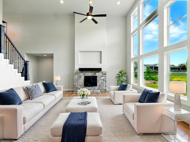 1016 W Mountain Orchard Dr, Pleasant View, UT 84414 - living area featuring a towering ceiling, ceiling fan, wood finished floors, a stone fireplace, and recessed lighting