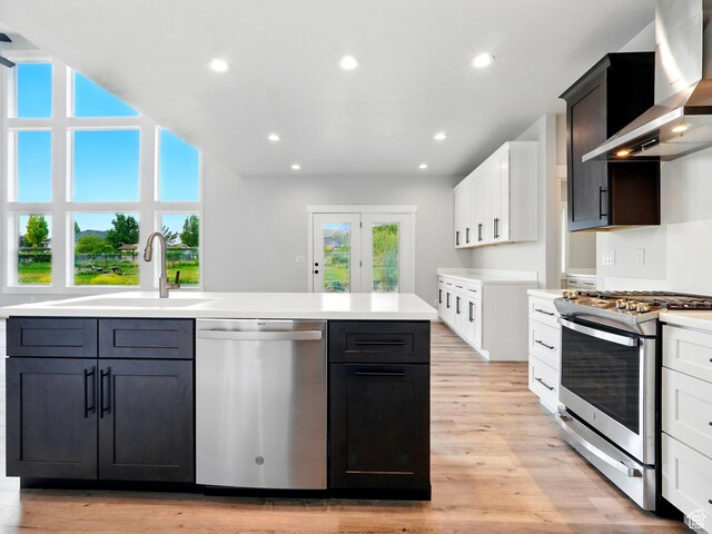 1016 W Mountain Orchard Dr, Pleasant View, UT 84414 - kitchen featuring appliances with stainless steel finishes, wall chimney exhaust hood, a sink, light countertops, and recessed lighting