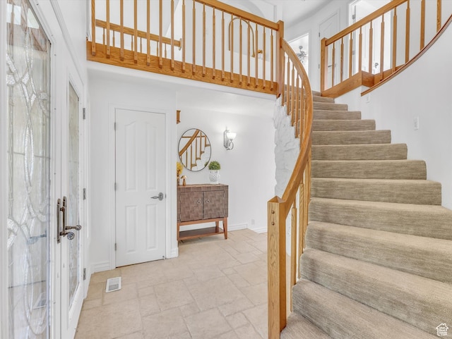 3351 E Deer Hollow Cir S, Sandy, UT 84092 - staircase featuring a towering ceiling, stone tile floors, and baseboards