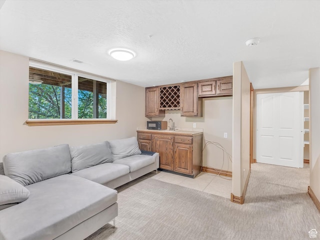 3351 E Deer Hollow Cir S, Sandy, UT 84092 - living room featuring bar with sink, baseboards, and light tile patterned floors