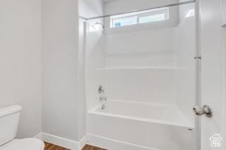 303 W 435 N, Vineyard, UT 84059 - bathroom with toilet, wood finished floors, baseboards, and  shower combination