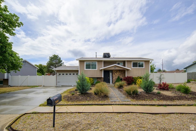 7648 S 2290 W, West Jordan, UT 84084 - bi-level home with driveway, fence, an attached garage, and brick siding
