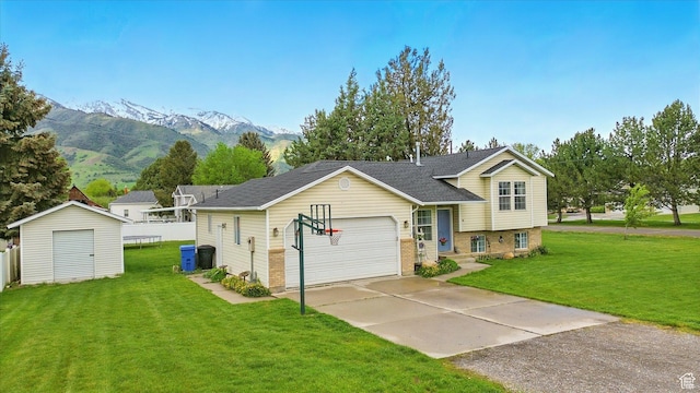 211 S 300 E, Wellsville, UT 84339 - tri-level home featuring a front yard, a mountain view, a storage unit, concrete driveway, and an attached garage