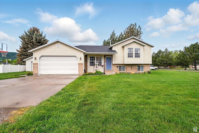 211 S 300 E, Wellsville, UT 84339 - tri-level home featuring brick siding, an attached garage, concrete driveway, and roof with shingles