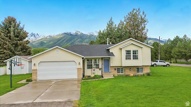 211 S 300 E, Wellsville, UT 84339 - tri-level home featuring a mountain view, a front yard, brick siding, and an attached garage