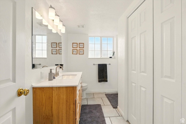 211 S 300 E, Wellsville, UT 84339 - bathroom with tile patterned flooring, toilet, vanity, a closet, and a textured ceiling