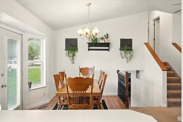 211 S 300 E, Wellsville, UT 84339 - dining space featuring a chandelier, wood finished floors, baseboards, vaulted ceiling, and stairs