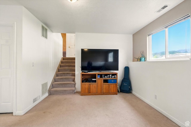 211 S 300 E, Wellsville, UT 84339 - carpeted living room featuring baseboards and stairs
