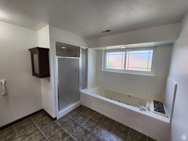 11258 S Brandon Park Dr E, Sandy, UT 84092 - bathroom featuring a jetted tub, a stall shower, a textured ceiling, tile patterned floors, and baseboards