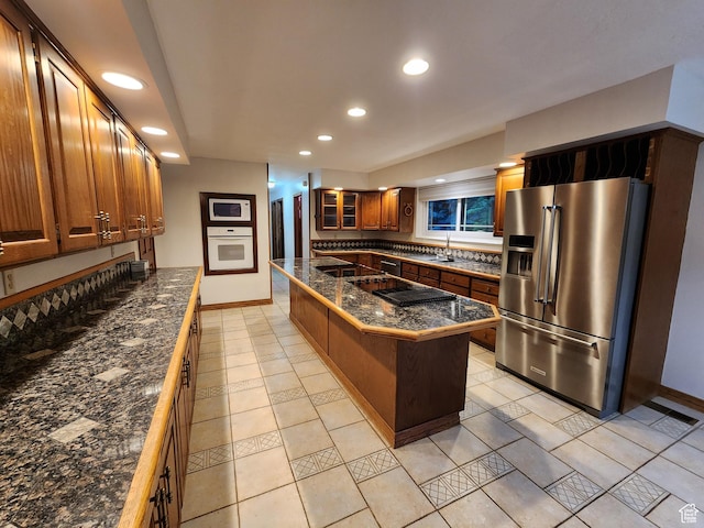 kitchen featuring white appliances, recessed lighting, baseboards, glass insert cabinets, and tile counters