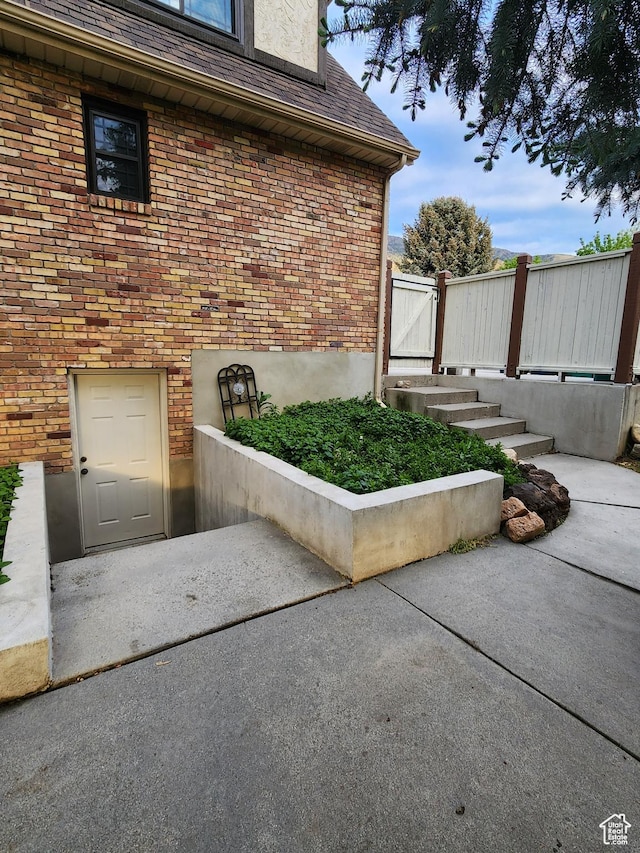 view of exterior entry featuring brick siding
