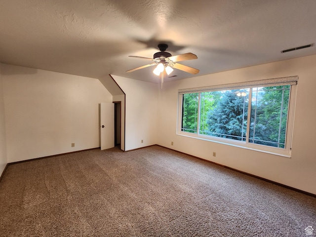 carpeted empty room featuring ceiling fan and baseboards