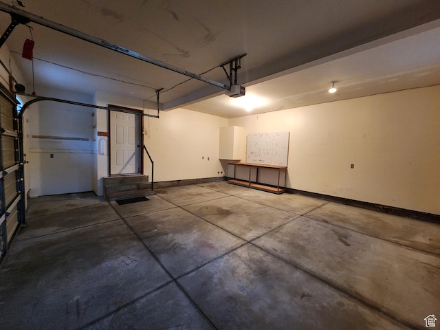 garage with a garage door opener and baseboards
