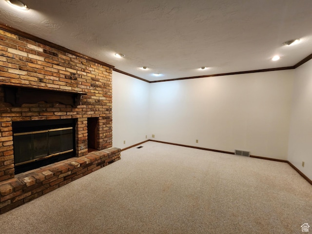 unfurnished living room featuring carpet, ornamental molding, baseboards, and a brick fireplace