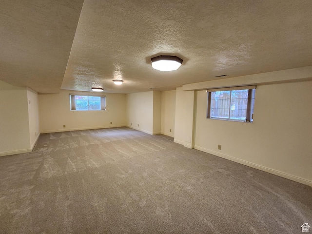 11258 S Brandon Park Dr E, Sandy, UT 84092 - below grade area featuring a textured ceiling, light carpet, and baseboards