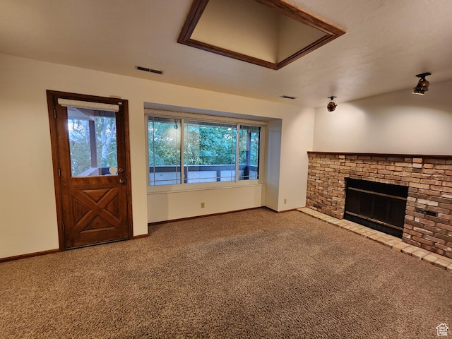unfurnished living room featuring carpet, a brick fireplace, and baseboards