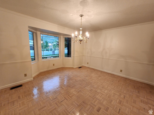 empty room with a chandelier, baseboards, and ornamental molding