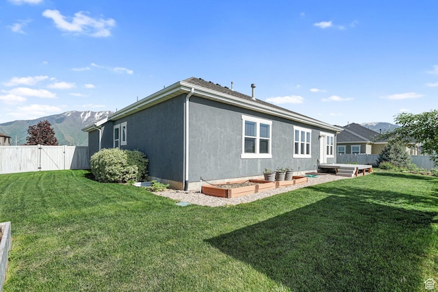 607 N 1980 E Unit 139, Spanish Fork, UT 84660 - rear view of property featuring a mountain view, a gate, stucco siding, and a garden